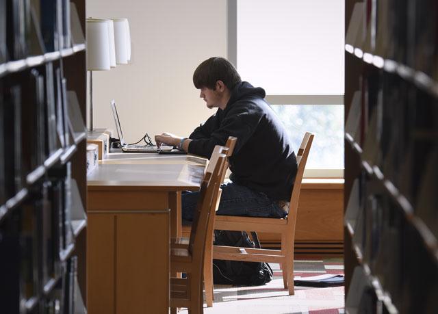 A male student studies in a library